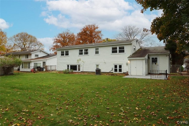 rear view of property with central air condition unit, a patio area, and a yard