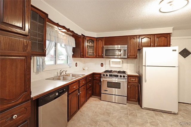 kitchen featuring sink, stainless steel appliances, and a textured ceiling