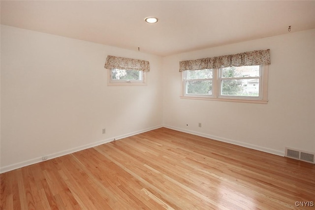 spare room with light wood-type flooring