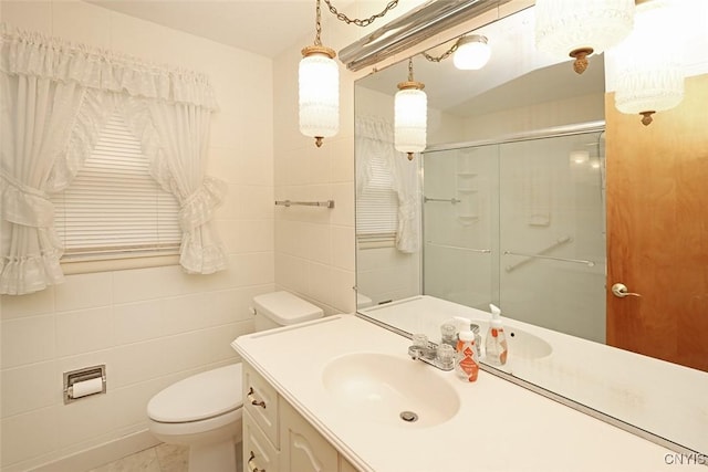 bathroom featuring an enclosed shower, vanity, tile walls, tile patterned flooring, and toilet