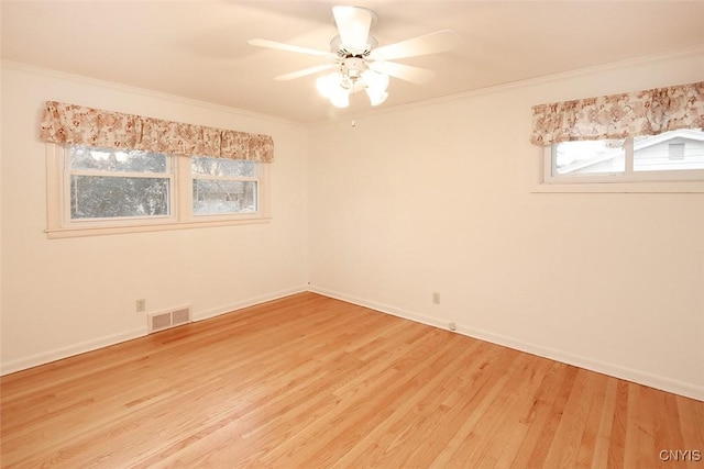 spare room featuring light wood-type flooring, ceiling fan, and ornamental molding