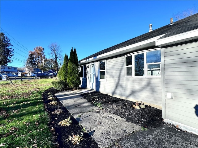 view of property exterior with a lawn