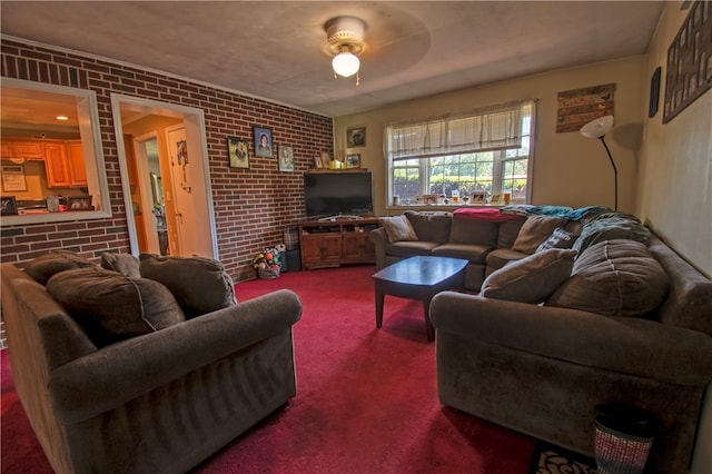 living room featuring brick wall, carpet, and ceiling fan