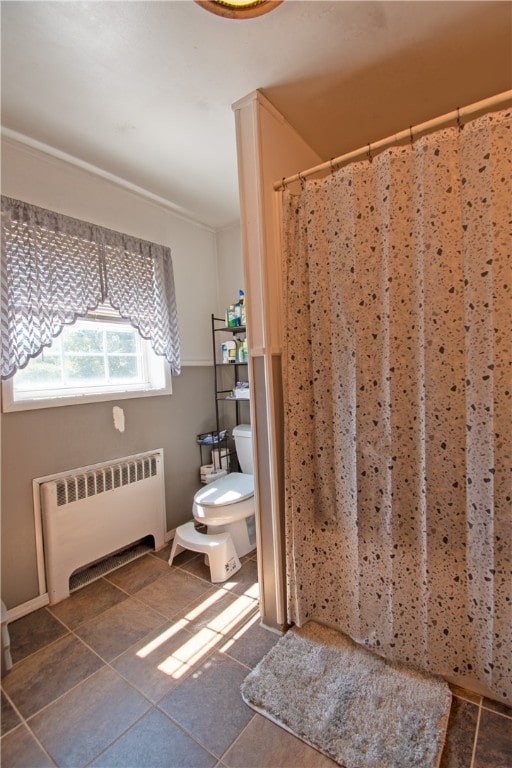 bathroom with radiator heating unit and toilet