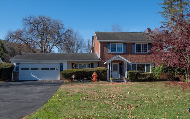 view of front of house with a front yard and a garage