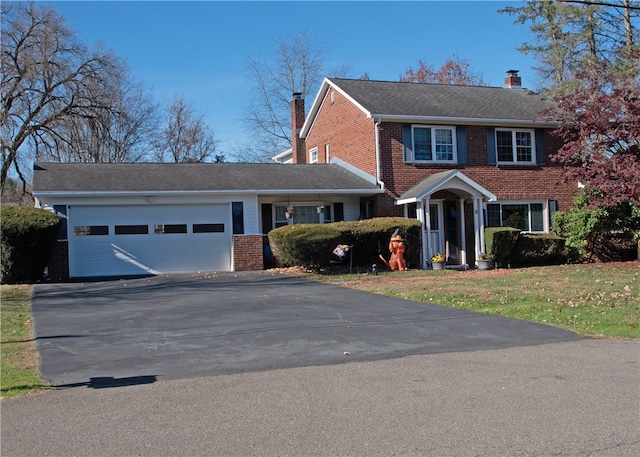 view of front of house featuring a front yard and a garage