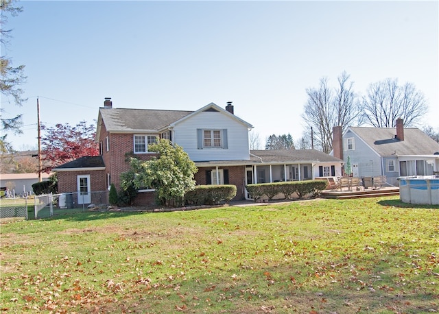 rear view of house with a yard and central air condition unit