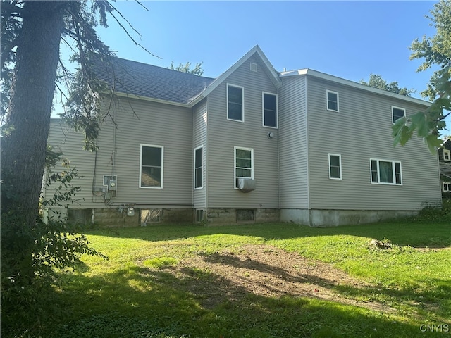 rear view of house with a yard