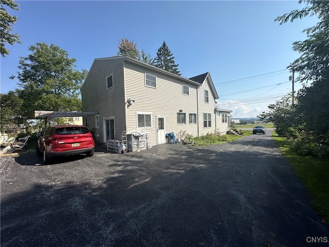 view of home's exterior featuring a carport