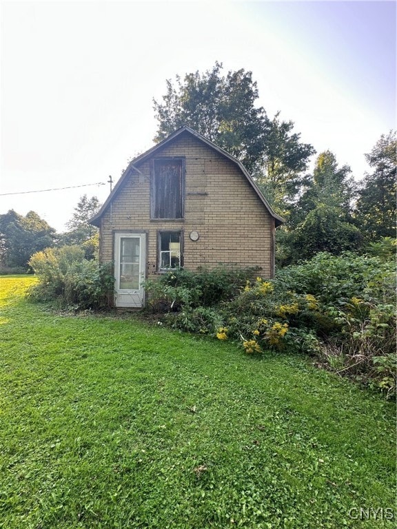 view of side of home featuring a yard