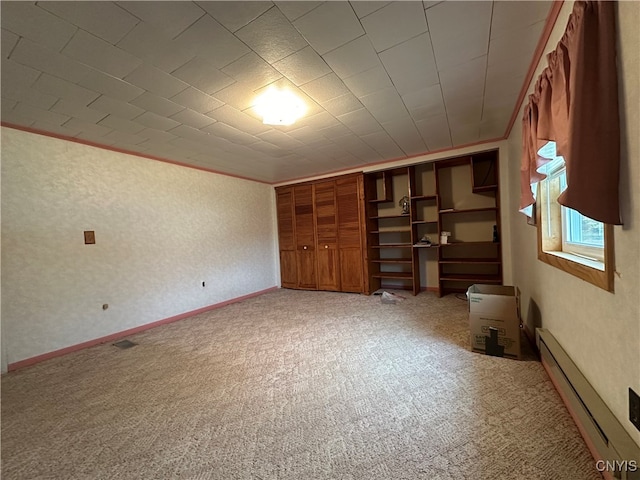 unfurnished bedroom with a baseboard radiator, ornamental molding, and carpet floors