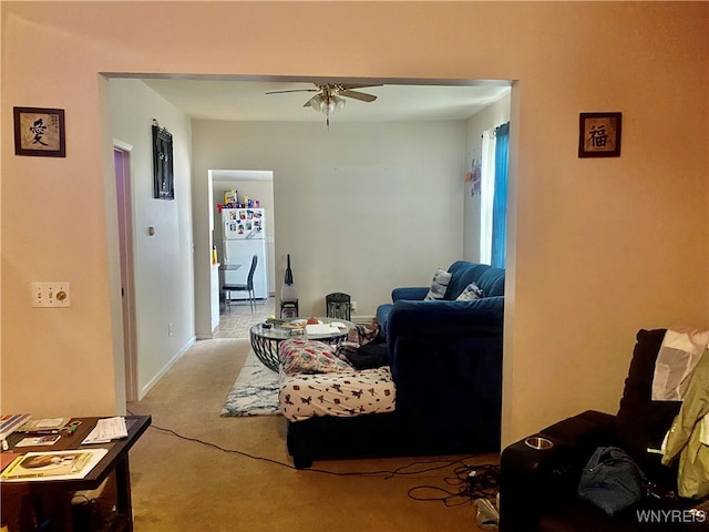 living room featuring ceiling fan and light carpet