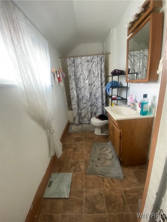 bathroom with walk in shower, vanity, toilet, and lofted ceiling