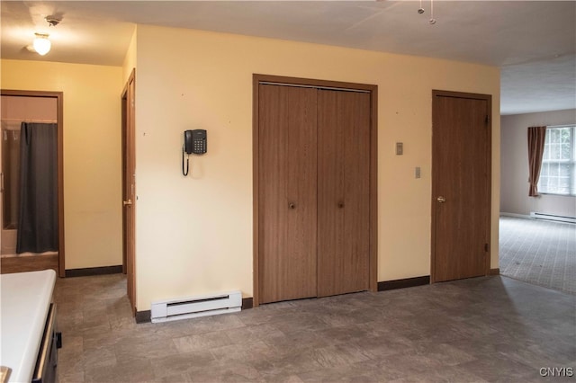 unfurnished bedroom with a baseboard heating unit