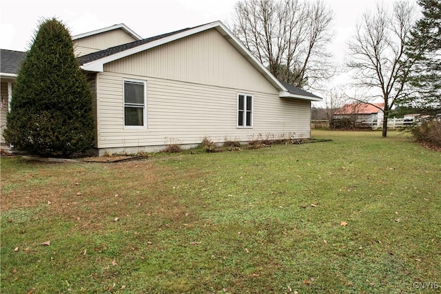 view of property exterior with a lawn