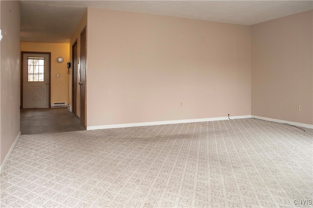 carpeted empty room with a baseboard radiator