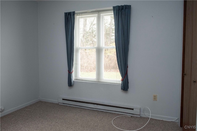 carpeted spare room featuring a baseboard radiator and a wealth of natural light