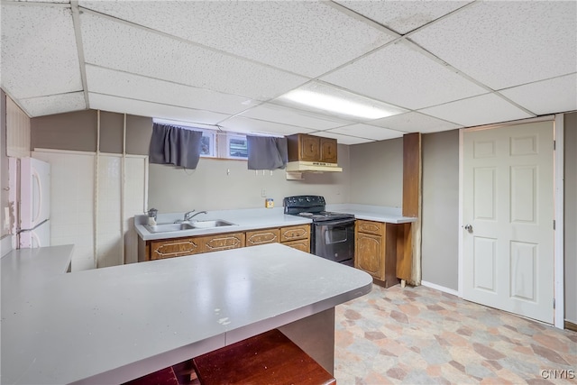 kitchen with a drop ceiling, black range with electric stovetop, and sink