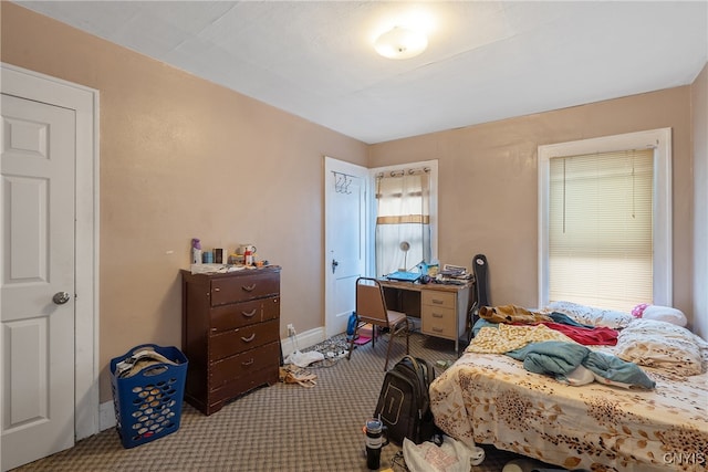 bedroom featuring light colored carpet