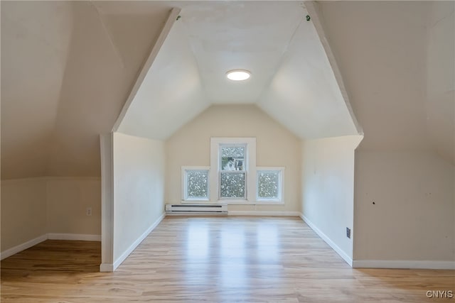 bonus room featuring light hardwood / wood-style flooring, lofted ceiling, and a baseboard radiator