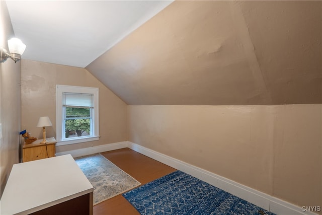 bonus room with hardwood / wood-style floors and vaulted ceiling