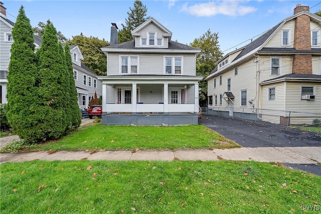 view of front of property with covered porch and a front lawn