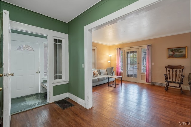 entrance foyer featuring ornamental molding and hardwood / wood-style flooring