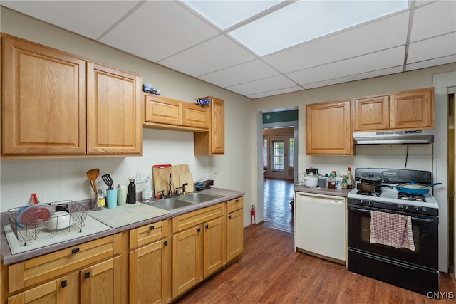 kitchen with sink, a drop ceiling, white dishwasher, black gas range oven, and dark hardwood / wood-style floors