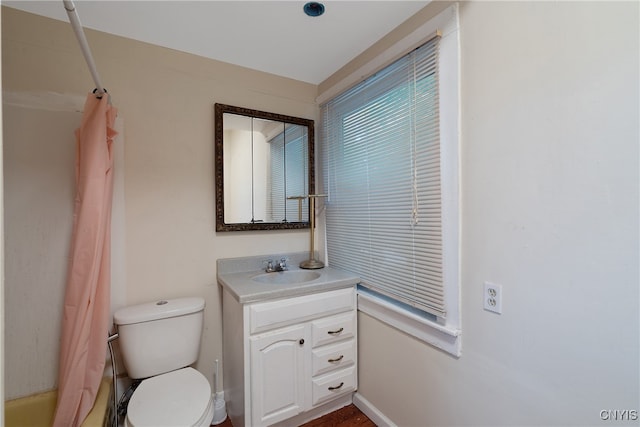 full bathroom featuring toilet, shower / tub combo with curtain, and vanity