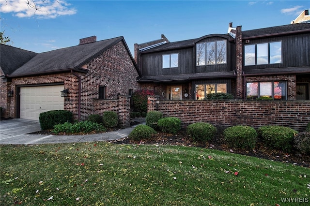 view of front of home with a garage and a front lawn