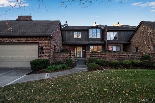 view of front of house with a front yard and a garage