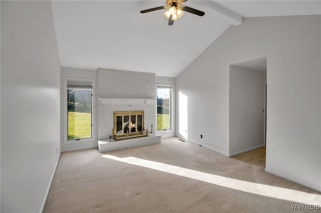 unfurnished living room with beam ceiling, light colored carpet, a fireplace, high vaulted ceiling, and ceiling fan