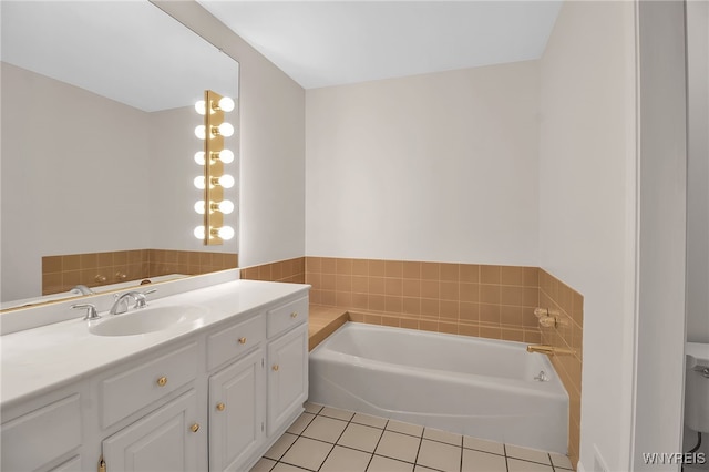 bathroom with a bathing tub, vanity, and tile patterned flooring