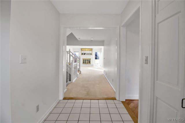 hallway featuring light colored carpet