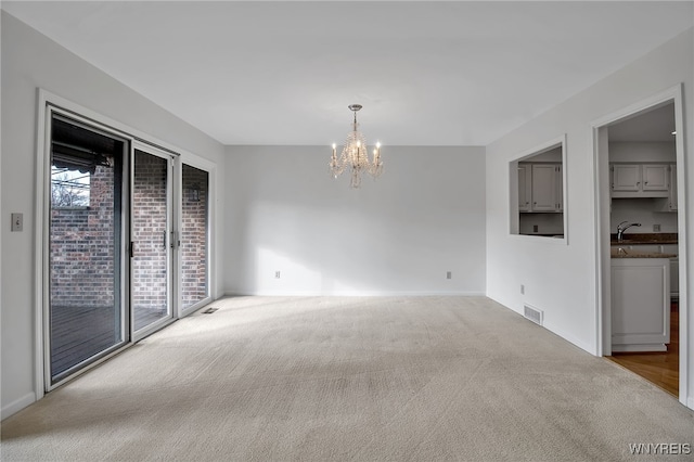 interior space with a chandelier and carpet flooring