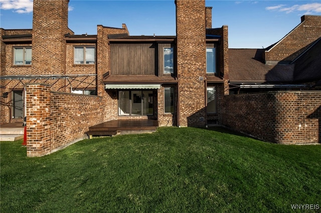 rear view of house featuring a yard