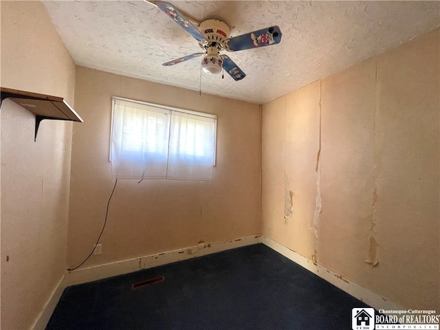 spare room with a textured ceiling and ceiling fan