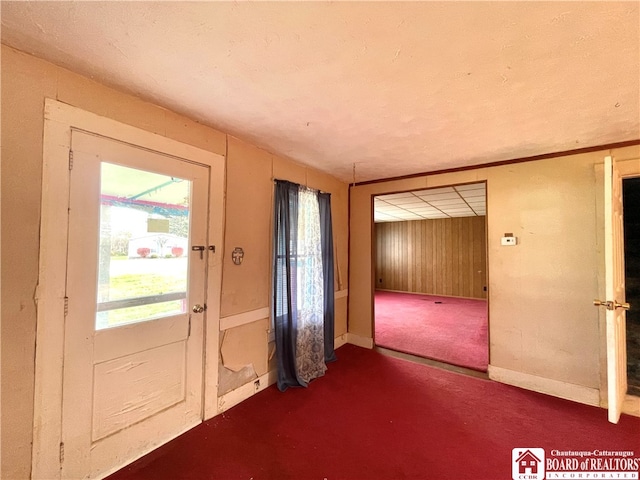 doorway featuring dark colored carpet