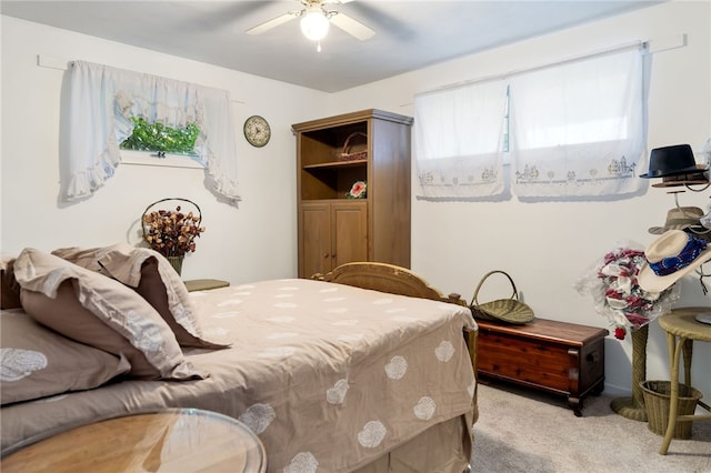 bedroom featuring light carpet and ceiling fan