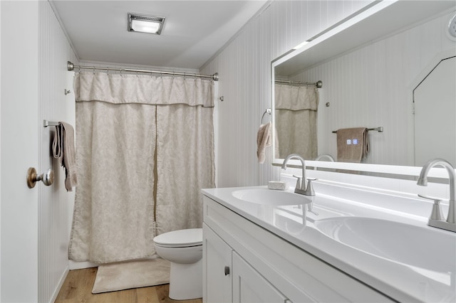 bathroom featuring hardwood / wood-style floors, vanity, a shower with shower curtain, and toilet