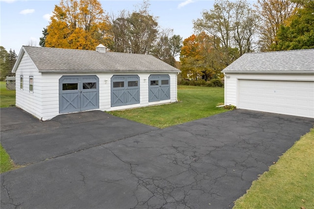 garage featuring a lawn