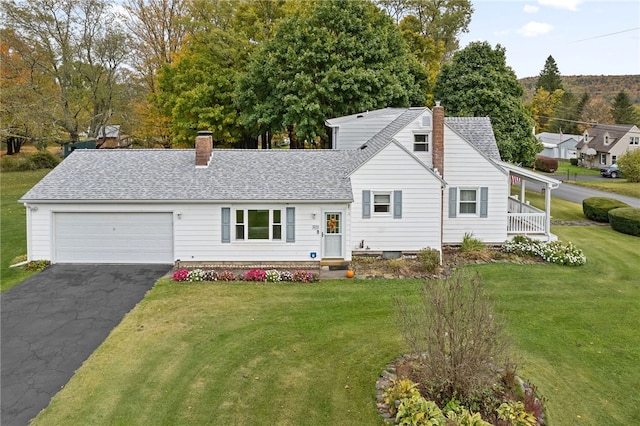 view of front of house with a garage and a front lawn