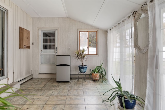 unfurnished sunroom with lofted ceiling and a baseboard heating unit