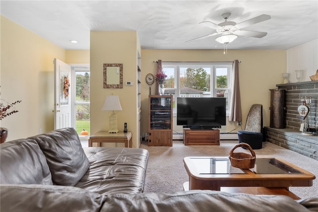 carpeted living room featuring ceiling fan, a fireplace, and a baseboard radiator