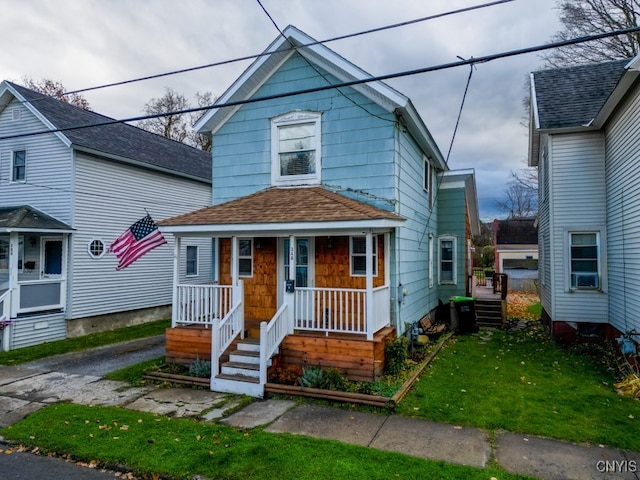 view of front of home featuring cooling unit and a front lawn