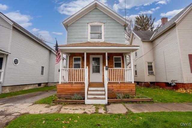 bungalow-style home featuring a porch and a front lawn