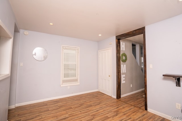 unfurnished room with hardwood / wood-style floors