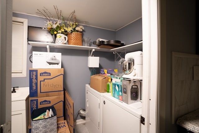 laundry area featuring independent washer and dryer, ornamental molding, and sink