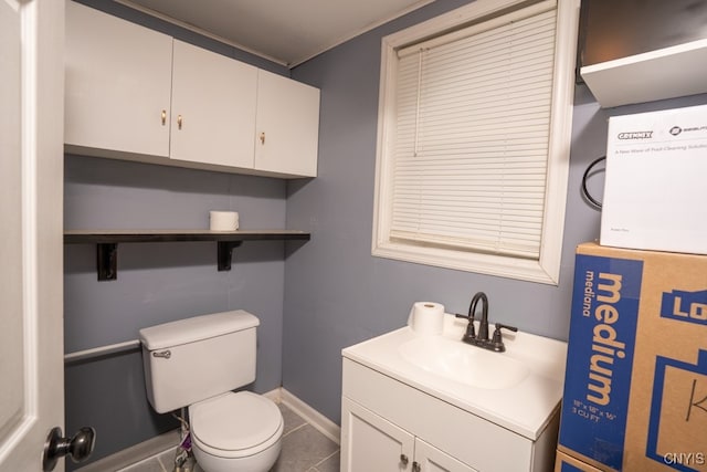 bathroom featuring toilet, vanity, and tile patterned floors