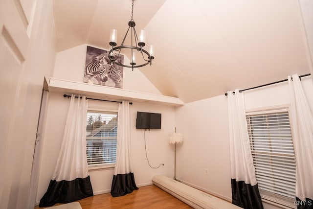 bathroom featuring lofted ceiling, a notable chandelier, and wood-type flooring